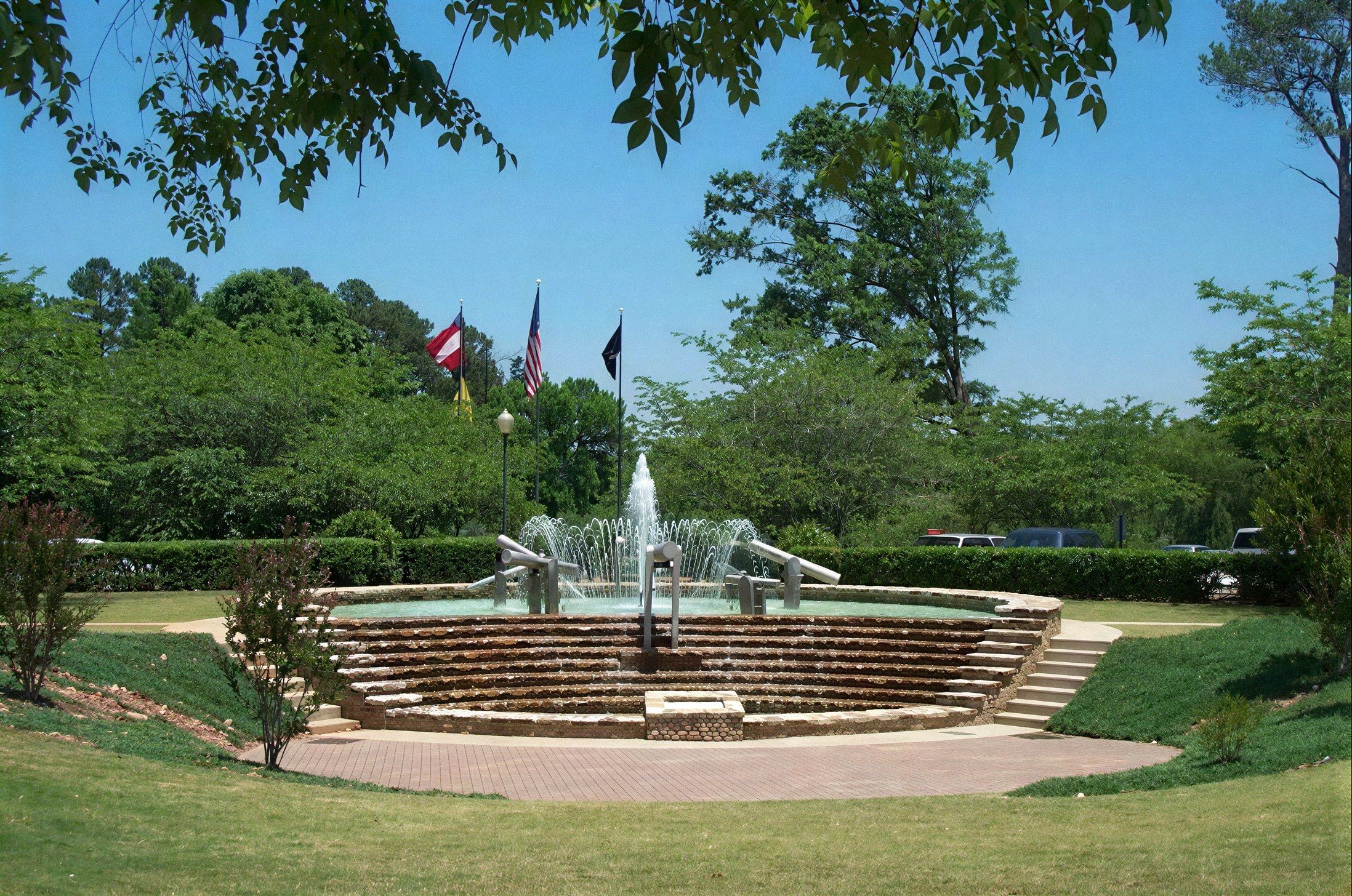 Fountain and flags in a landscaped park in Peachtree City, GA